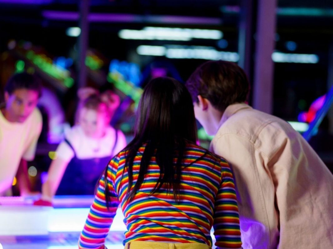 Children playing air hockey in a holiday park games room